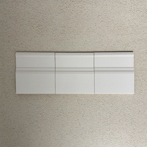 Flat lay of Finchley White 15 × 15cm ceramic skirting tiles with a crackle glaze finish, designed to create a smooth, decorative transition between wall and floor in classic interior spaces.
