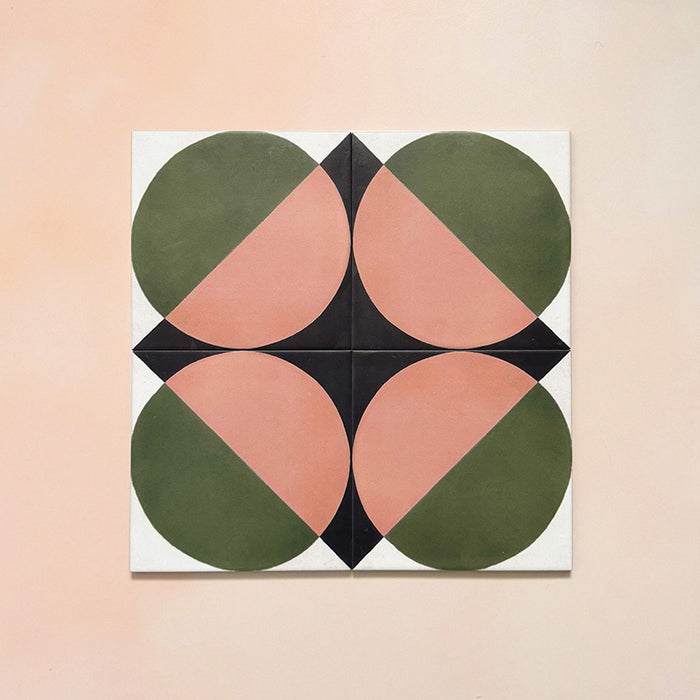 Group image showing four Geometry Moon 20x20cm geometric patterned tiles arranged to form a circular motif, featuring green and terracotta semicircles with black and cream corner details, photographed against a soft peach-toned background.