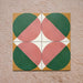 Group image showing four Geometry Paloma 20x20cm geometric patterned tiles arranged to form a circular motif, featuring pink and green semicircles with mustard and cream corner accents, photographed against a textured stone background.