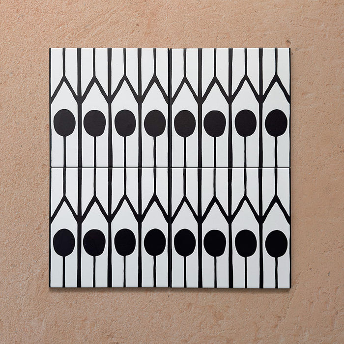 Alhambra Felisa 20x20cm Moroccan tiles displayed in a set of four, showcasing a bold black and white pattern with teardrop-shaped motifs and fine vertical lines for a modern Moroccan-inspired look.