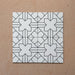 Alhambra Palacio 20x20cm Moroccan tiles arranged in a 4-tile layout, showcasing a bold black geometric cross motif on a white base for a clean, modern Moroccan design.
