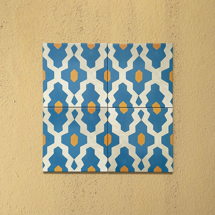 Cabana Zafini Mustard Azure 20x20cm Moroccan-style porcelain tiles arranged in a four-tile layout, displaying a repeating geometric pattern in vibrant azure blue and mustard yellow on a cream base with a smooth matt finish.