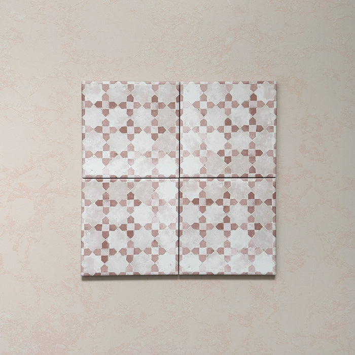 Bedouin Mequinez Rose Moroccan-style 15x15cm set of four tiles displayed together, showing a repeating geometric design in blush pink, beige, and white tones with a handcrafted, matte surface and soft textured detailing.