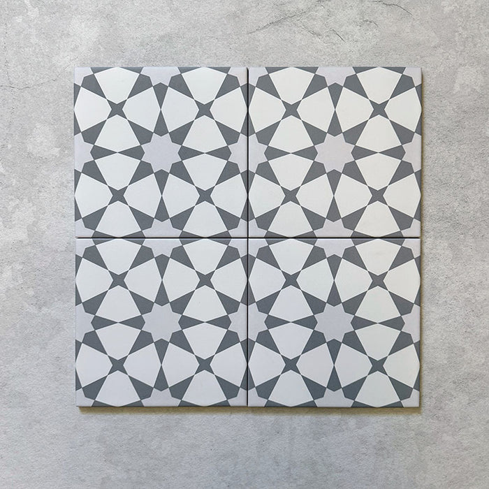 Grouped display of Agraba Silver 20cm x 20cm Moroccan style matt ceramic tiles, showing a repeating silver and white geometric pattern inspired by traditional Moorish design, suitable for walls and floors indoors and outdoors.