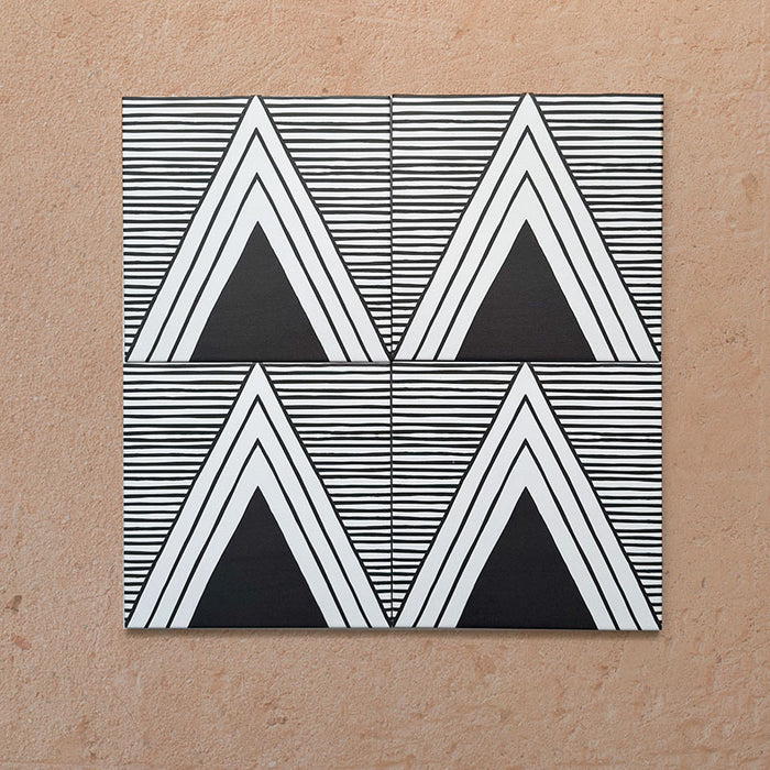 Alhambra Pyramid 20x20cm Moroccan tiles arranged in a four-tile layout, featuring bold black and white triangular patterns with fine horizontal lines for a modern geometric effect.