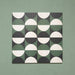 Group image showing four Geometry Circulo 20x20cm geometric patterned tiles arranged to form a circular repeat, featuring green, black, and cream semicircle motifs, photographed against a soft green textured background.