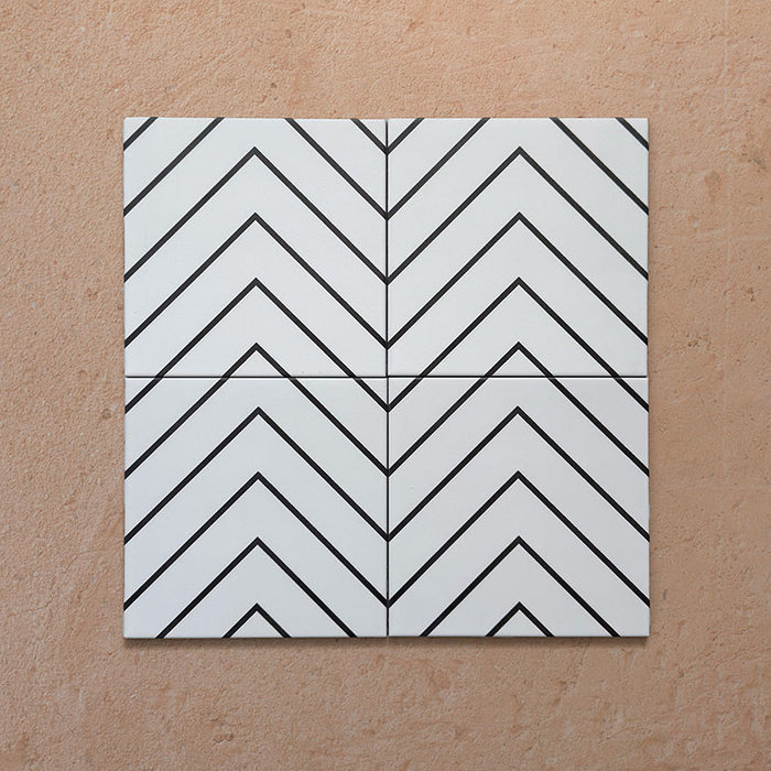 Alhambra Zig Zag Blanco 20x20cm Moroccan tiles displayed in a four-tile arrangement, featuring a bold black chevron pattern on a white background for a clean and modern geometric effect.
