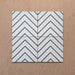 Alhambra Zig Zag Blanco 20x20cm Moroccan tiles displayed in a four-tile arrangement, featuring a bold black chevron pattern on a white background for a clean and modern geometric effect.
