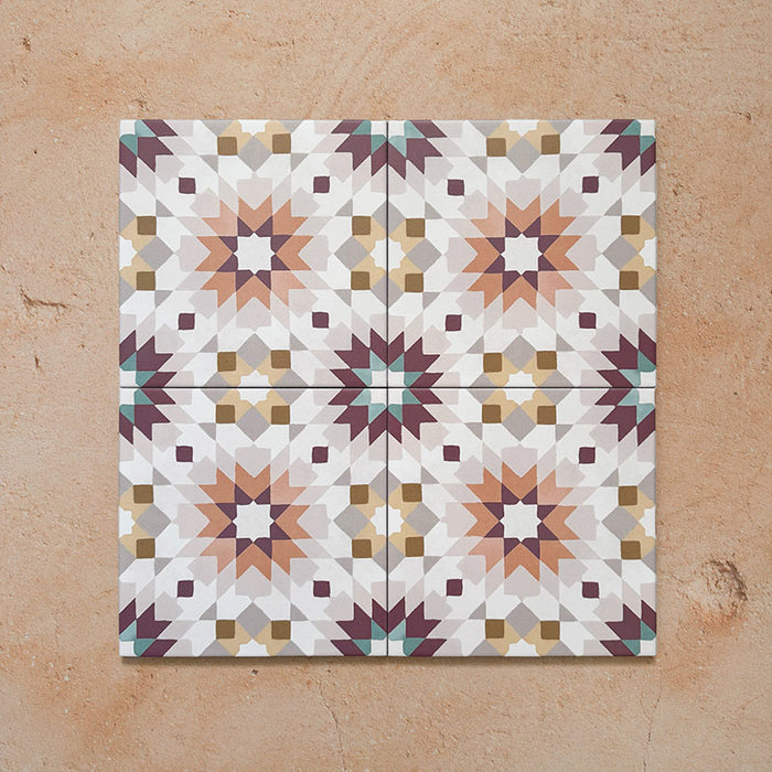 Cabana Manzanillo 20x20cm Moroccan-style porcelain tiles showing a four-tile layout with a geometric starburst pattern in blush pink, mustard, terracotta, lilac, and turquoise shades on a soft matt surface.