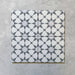 Agraba Silver 20x20cm Moroccan tiles displayed as a set of four, showing the intricate grey and white geometric star design ideal for creating elegant patterned floors or feature walls.