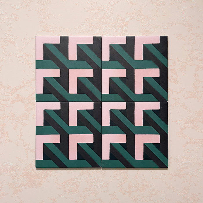 Four-tile layout featuring Geometry Lagoon 20x20cm patterned ceramic tiles, showing an interlocking geometric design in blush pink, deep teal, and charcoal tones, displayed against a textured beige backdrop.