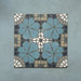 Four Bloom Azul Blue 20x20cm Moroccan-style ceramic tiles displayed together, featuring a symmetrical floral pattern in blue, grey, beige, and white tones on a textured blue background.