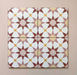Close-up of four Agraba Springs 20x20cm Moroccan-style ceramic tiles showing a geometric star pattern in terracotta, blush pink, mustard, and white tones on a soft pastel background.