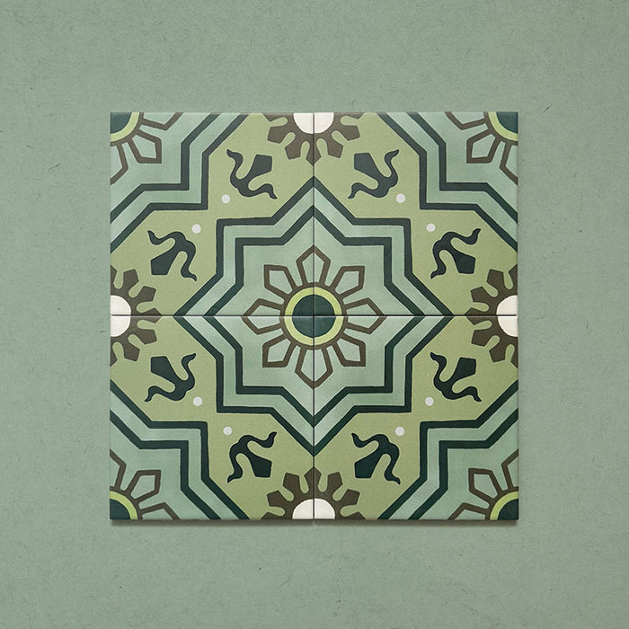 Four Brompton Verde 20x20cm Victorian-style ceramic tiles arranged together, showing a detailed geometric star and floral motif in rich green, teal, and cream tones on a soft green background.