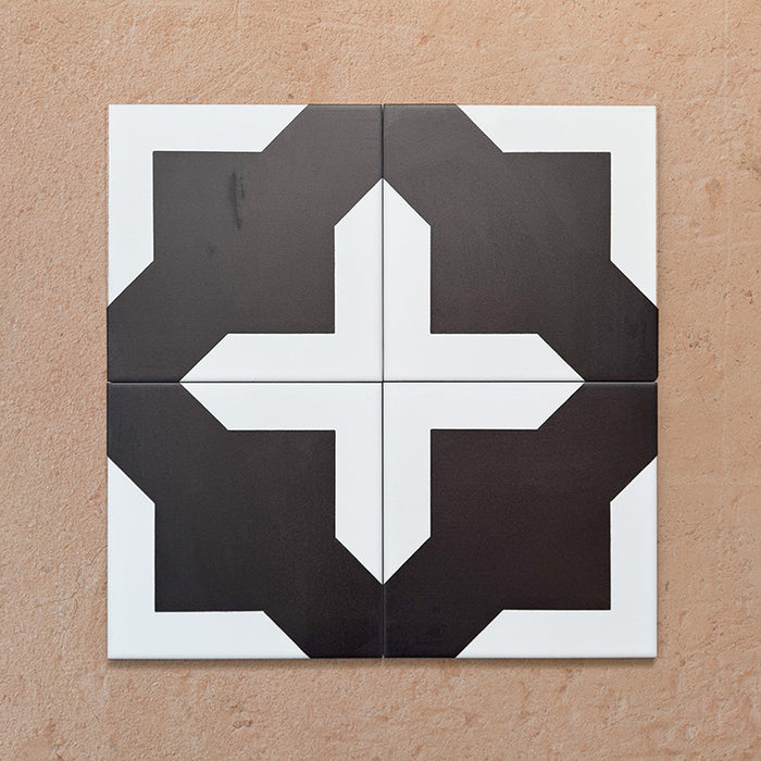 Alhambra Cathedral 20x20cm Moroccan tiles arranged in a four-tile layout, showcasing a bold black and white cross motif with clean geometric lines — perfect for adding statement style to modern interiors.