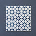 Close-up of four Agraba Navy 20x20cm Moroccan-style ceramic tiles arranged together, displaying a geometric star pattern in deep navy blue and white on a dark textured background.