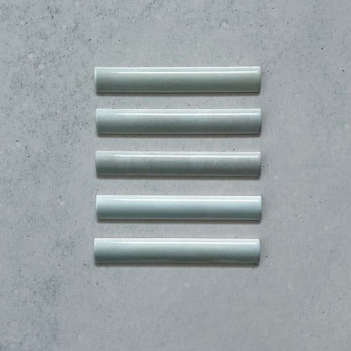 Zellij Aqua Blue Bullnose Moroccan Style 3cm x 20cm glazed ceramic trim tile in soft aqua blue tones, smooth rounded bullnose edge, glossy finish, handcrafted zellige look with subtle tonal variation, ideal for edging walls, niches, and decorative tile layouts.