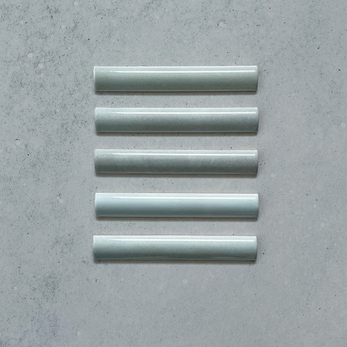 Zellij Aqua Blue Bullnose Moroccan Style 3cm x 20cm glazed ceramic trim tile in soft aqua blue tones, smooth rounded bullnose edge, glossy finish, handcrafted zellige look with subtle tonal variation, ideal for edging walls, niches, and decorative tile layouts.