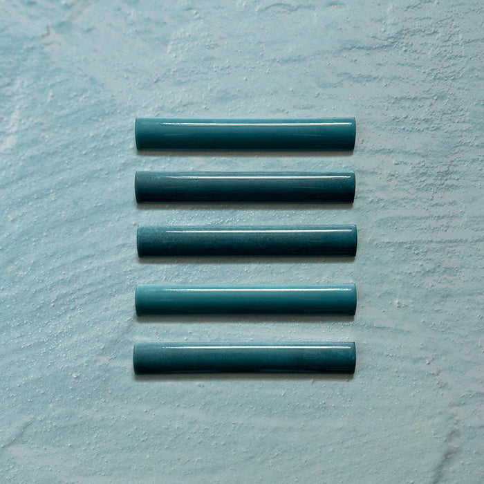 Zellij Peacock Green bullnose tile, 3cm x 20cm, Moroccan style glazed ceramic trim in deep peacock green tones with subtle tonal variation, glossy finish, smooth rounded profile, and handcrafted-inspired surface texture, shown as a set of bullnose pieces on a pale textured background.