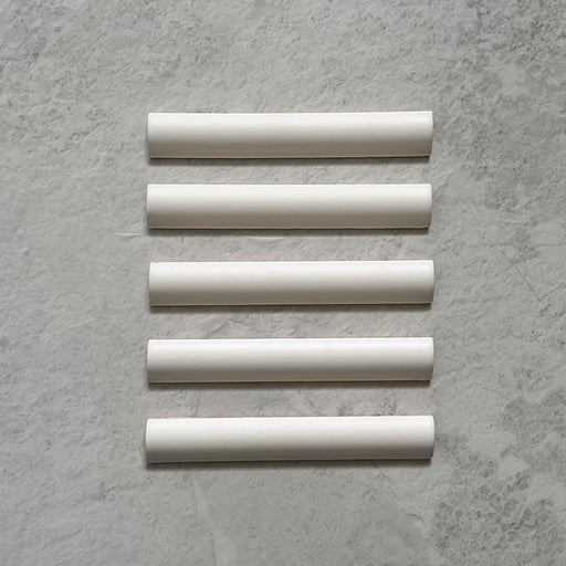 Zellij Chalk White Bullnose Moroccan-style trims in a 3cm x 20cm format, featuring a soft matt white finish and smooth rounded profile, displayed as a flat lay on a neutral stone-effect background.