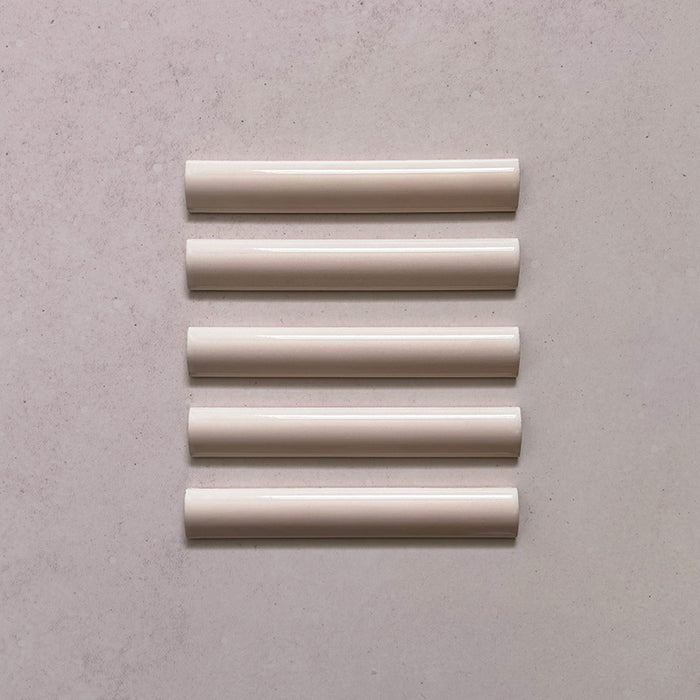 Zellij Pink Mist bullnose trim tile, 3cm x 20cm, soft blush pink tone, glossy glazed finish, smooth rounded edge, handcrafted Moroccan style.