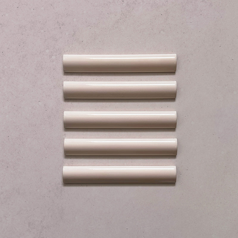 Zellij Pink Mist bullnose trim tile, 3cm x 20cm, soft blush pink tone, glossy glazed finish, smooth rounded edge, handcrafted Moroccan style.