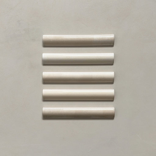 Zellij Bone bullnose tile in a 3cm x 20cm format, Moroccan style, featuring soft bone-beige tones, a glossy finish, and gentle handmade surface variation, shown as a flat lay of five trims on a neutral background.