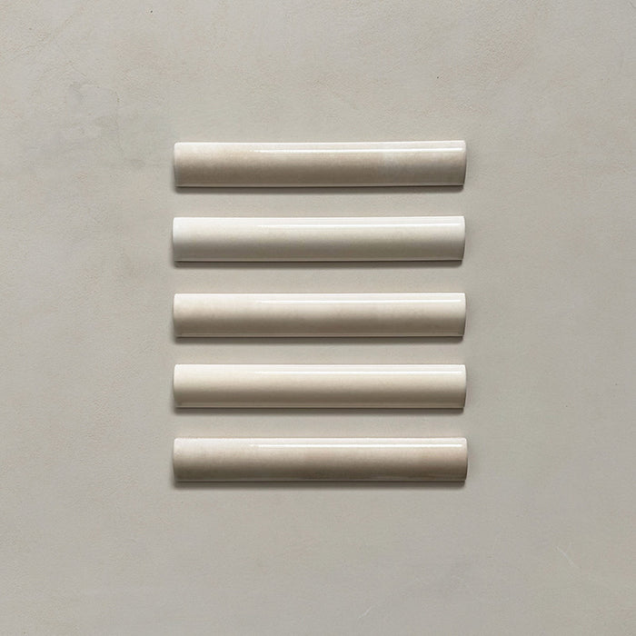 Zellij Bone bullnose tile in a 3cm x 20cm format, Moroccan style, featuring soft bone-beige tones, a glossy finish, and gentle handmade surface variation, shown as a flat lay of five trims on a neutral background.