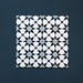 Close-up of four Agraba Azul Blue 20x20cm Moroccan-style ceramic tiles arranged together, showing a geometric star pattern in navy, light blue, and white tones on a deep blue background.