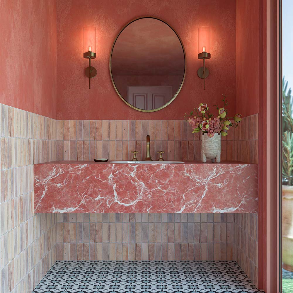 Agraba Azul Blue 20cm x 20cm Moroccan style tiles used across a bathroom floor, featuring a bold blue and white geometric pattern, paired with soft pink wall tiles, coral-toned walls and a statement marble vanity.