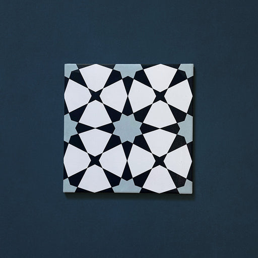 Close-up of Agraba Azul Blue 20x20cm Moroccan-style ceramic tile featuring a geometric star pattern in navy, light blue, and white tones on a deep blue background.