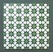 Group of Agraba Green 20x20cm Moroccan-style ceramic tiles showing a repeated geometric star pattern in rich green and white tones, displayed on a dark green background to highlight the intricate design.