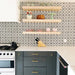 Kitchen featuring Agraba Black and White Mini 15x15cm Moroccan-style ceramic wall tiles used as a backsplash, styled with open wooden shelving, brass hardware, and modern grey cabinetry for a bold patterned look.