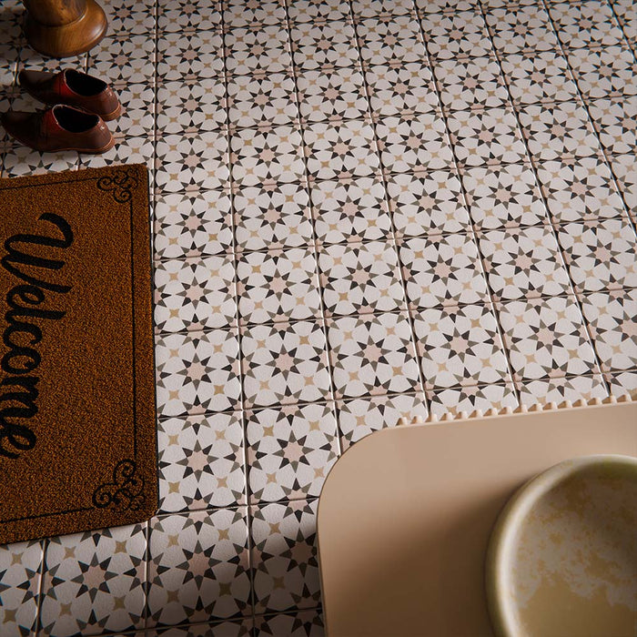 Hallway interior featuring Agraba Natural 20cm x 20cm Moroccan style ceramic floor tiles, showcasing a soft neutral geometric pattern, styled with dark green walls, classic panelling, and contemporary furniture.