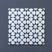 Close-up of four Agraba Navy 20x20cm Moroccan-style ceramic tiles arranged together, displaying a geometric star pattern in deep navy blue and white on a dark textured background.