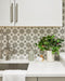 Kitchen featuring Agraba Silver 20cm x 20cm patterned splashback tiles, with a geometric star design in soft grey and white, paired with white cabinetry, worktops and brushed metal fixtures.