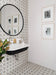 Bathroom featuring Agraba Silver 20cm x 20cm patterned wall and floor tiles, with a geometric star design in soft grey and white, paired with a black and white basin, round mirror and chrome fixtures.