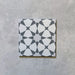 Product image of Agraba Silver 20cm x 20cm Moroccan style matt ceramic tile, featuring a soft silver and white geometric pattern inspired by traditional Moorish design, suitable for walls and floors, frost resistant and R11 anti-slip.