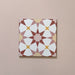 Close-up of Agraba Springs 20x20cm Moroccan-style ceramic tile featuring a geometric star pattern in terracotta, blush pink, mustard, and white tones on a soft pastel background.