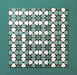 Group of Agraba Verde 20x20cm Moroccan-style ceramic tiles featuring a geometric star pattern in green, mint, and white tones, arranged on a teal background to showcase the intricate repeating design.
