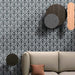 Alhambra Casa 20x20cm Moroccan tiles used in a living room setting, featuring a bold black and white fan-inspired geometric pattern that creates an elegant and dramatic statement wall behind a neutral sofa.