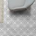 Alhambra Palacio 20x20cm Moroccan tiles used in a modern living room setting, featuring a refined black and white geometric cross design that adds a contemporary yet classic feel to the floor.