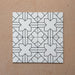 Alhambra Palacio 20x20cm Moroccan tiles arranged in a 4-tile layout, showcasing a bold black geometric cross motif on a white base for a clean, modern Moroccan design.
