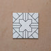 Alhambra Palacio 20x20cm Moroccan tile single tile shot, featuring a clean white background with an intricate black geometric cross pattern for a bold yet timeless design.