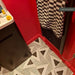 Customer bathroom featuring Alhambra Pyramid Moroccan style wall and floor tiles in a bold black and white geometric pattern, paired with rich red walls to create a striking, contemporary interior with graphic contrast.