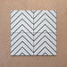 Alhambra Zig Zag Blanco 20x20cm Moroccan tiles displayed in a four-tile arrangement, featuring a bold black chevron pattern on a white background for a clean and modern geometric effect.