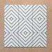 Alhambra Zig Zag Blanco 20x20cm Moroccan tiles shown in a grouped layout, featuring a bold black and white chevron pattern with diamond detailing for a contemporary geometric look.
