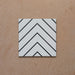 Alhambra Zig Zag Blanco 20x20cm Moroccan tile featuring a bold black chevron pattern on a white background, showcasing its modern geometric design and smooth matte finish.