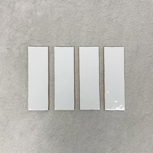 Close-up of Fusion Bricks Arctic White 6.5x20cm brick wall tiles, showcasing crisp white tones with subtle tonal variation and a lightly textured surface, highlighting a clean, handcrafted finish.