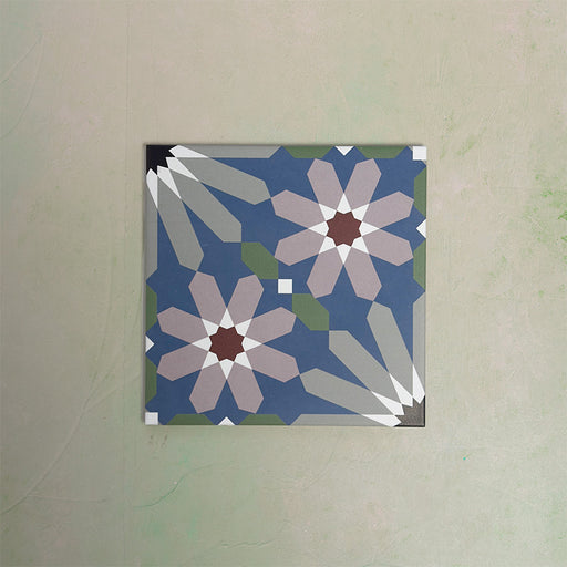 Fizaan Artisan Moroccan-style 20×20cm porcelain tile featuring a blue, green and soft pink geometric floral pattern.